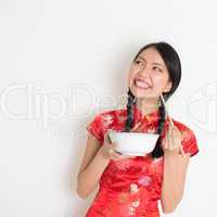 Asian chinese girl eating and looking up