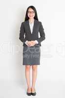 Full body smiling Asian business woman