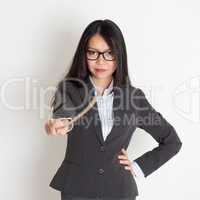 Asian female teacher holding a stick