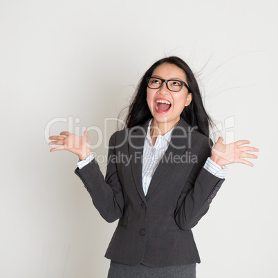 Asian business woman looking up