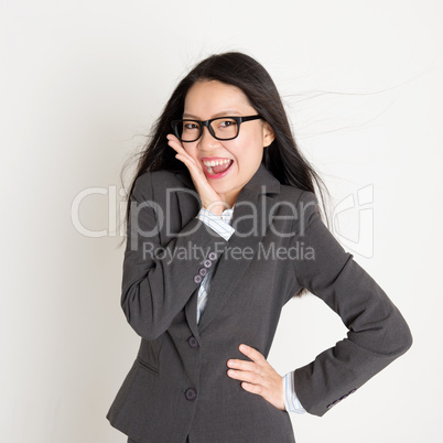 Surprised Asian business woman looking at camera