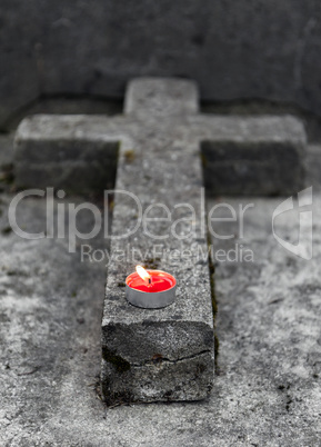 Tombstone with burning candle
