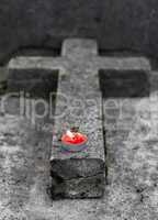 Tombstone with burning candle