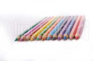 Twelve colored pencils in a row