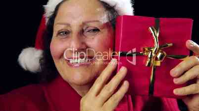Mature Woman With Santa Cap Caressing A Red Gift