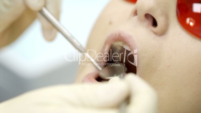 Woman being under dentists examination