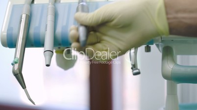 Dentist putting tool on its place after using
