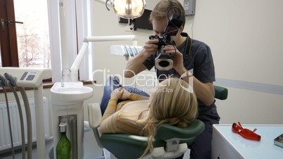 Dentist making shots of womans smile after treatment