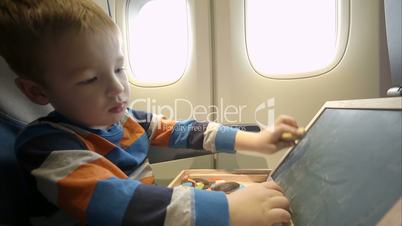 Little boy in the plane with wooden box