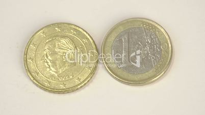 A gold plated coin and a 1 Belgium Euro coin