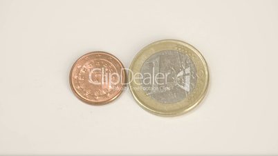 Small shiny bronze Portugal coin and a 1 Euro coin