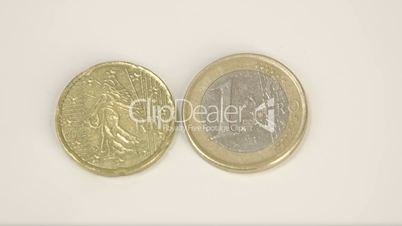 The gold plated France coin and 1 Euro coin on a table