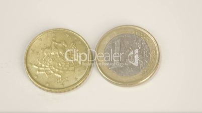 A 2002 version of a goldplated Italy coin and a 1 Euro coin