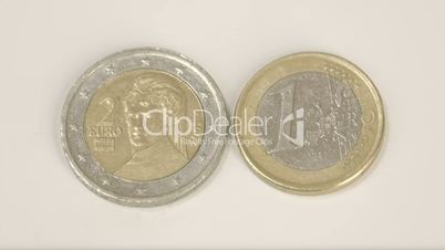 A 2 Austian Euro coin and 1 Austria Euro coin on the table