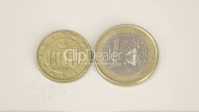 Showing the back detail of the smaller Germany coin and a 1 Euro coin
