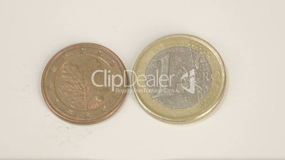 A bronze Germany coin and the 1 Euro coin