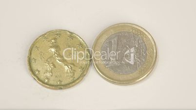 A bumpy sided Italy coin and a 1 Euro coin