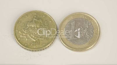 Euro Italy coins on the table one gold coin and a 1 Euro coin