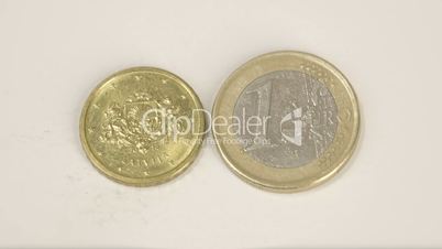 A small Latvija coin and a 1 Latvian Euro coin