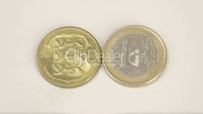 2003 version of an Estonia gold coin and a 1 Euro coin