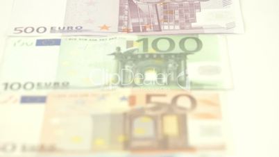 Five Euro bills being lined up on the table