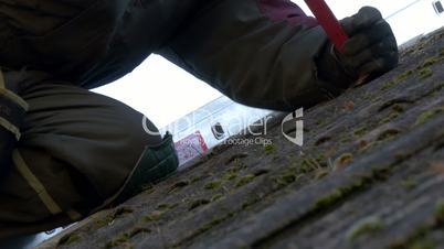Close up look of the roofer getting off the nails