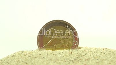 2 Euro coin standing on the white pebbles