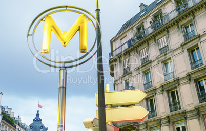 Subway sign in Paris with city building. Metro