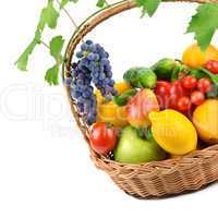 fruits and vegetables in a wicker basket isolated on white backg
