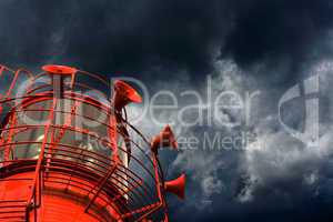 Red lightship with fog horns against storm clouds