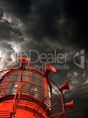 Red lightship with fog horns against storm clouds