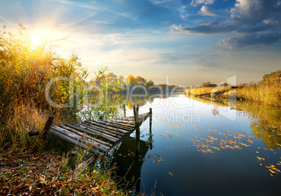 Old pier on autumn river