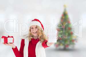 Composite image of festive blonde holding gift on right hand