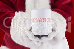 Composite image of santa holds a can for donations