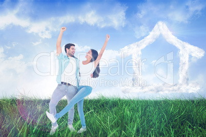 Composite image of happy casual couple cheering together