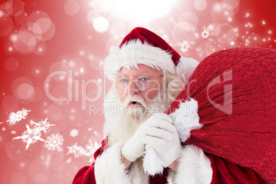 Composite image of santa holding sack