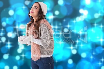 Composite image of brunette in winter clothes with hands out