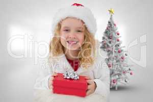 Composite image of cute girl with gift