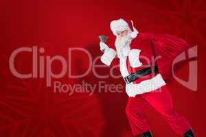 Composite image of santa walking with his sack and bell