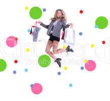 Composite image of stylish blonde jumping with shopping bags