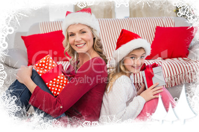 Composite image of festive mother and daughter smiling at camera