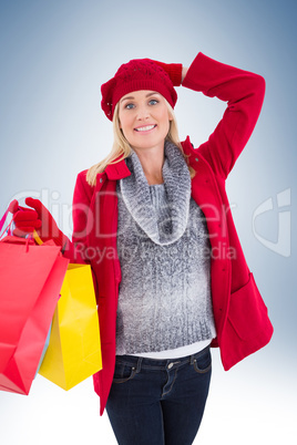 Blonde in winter clothes holding shopping bags