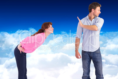 Composite image of man stopping woman from kissing