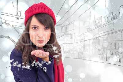 Composite image of festive brunette blowing a kiss