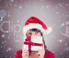 Composite image of portrait of a festive young woman holding a g