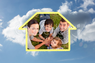 Composite image of young parents and kid lying on garden with ha