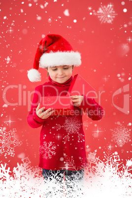 Composite image of festive little boy opening a gift