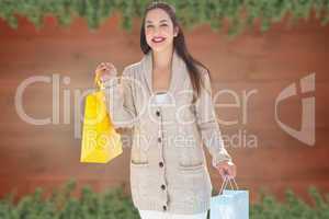 Composite image of woman with shopping bags