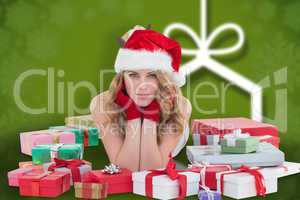 Composite image of woman in santa hat laying on the floor with g