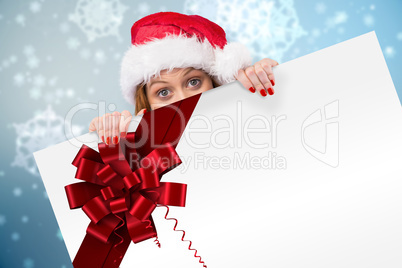 Festive redhead smiling at camera holding poster